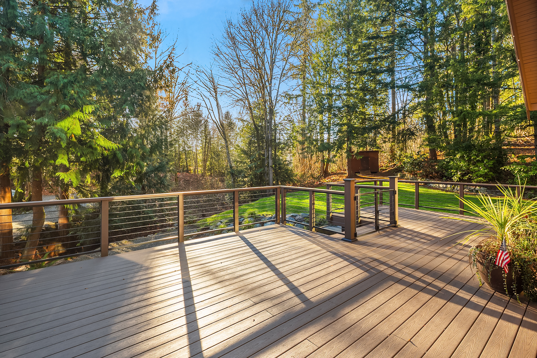 The wraparound deck looking out into the cedars at the rear of the residence